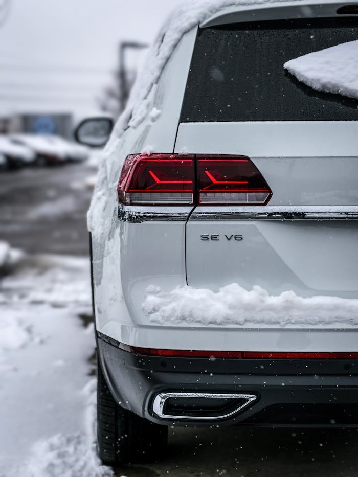 Close-up of a snow-covered SUV parked outdoors in winter.